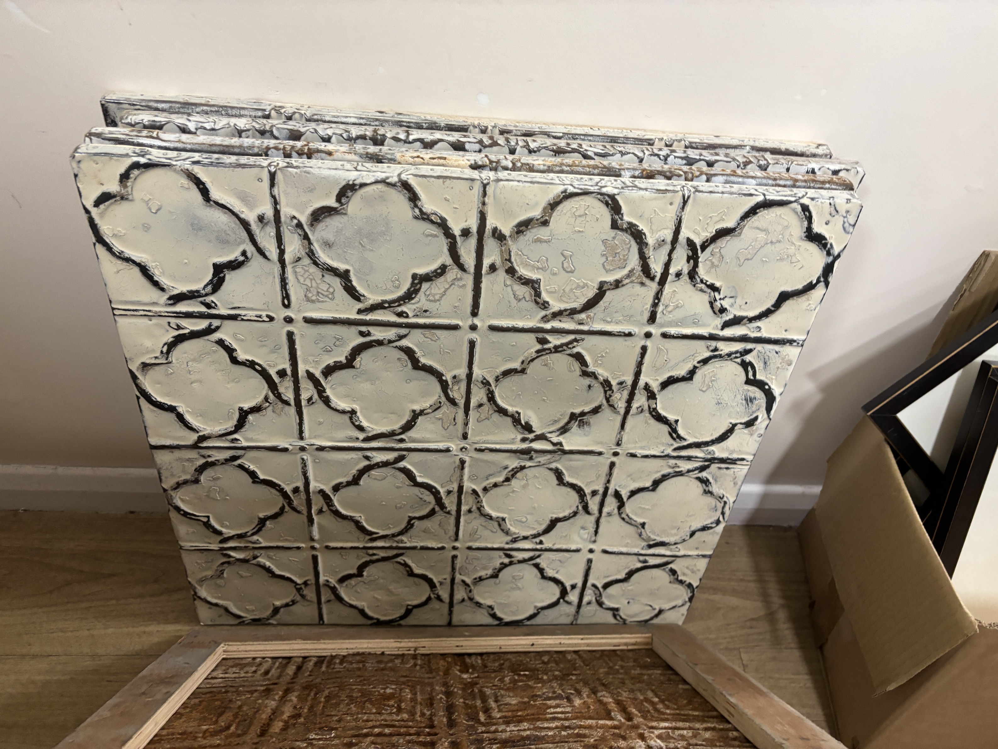 A group of nine decorative pressed tin panels made from salvaged antique tin ceilings, 59cm square